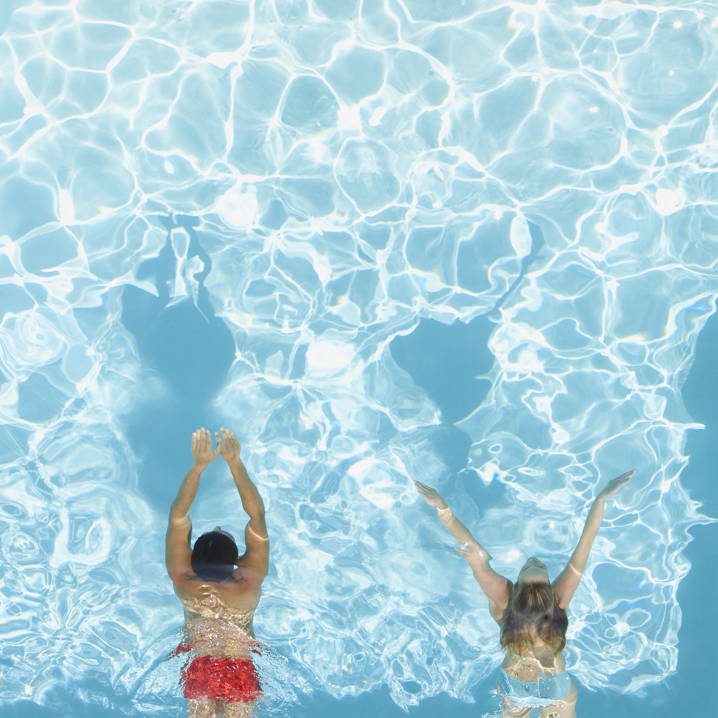 Clear swimming pool water highlighting a smooth Diamond Brite quartz pool resurfacing finish