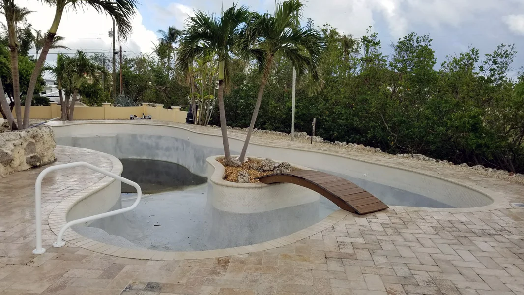 Old stained pool plaster before resurfacing in Miami FL