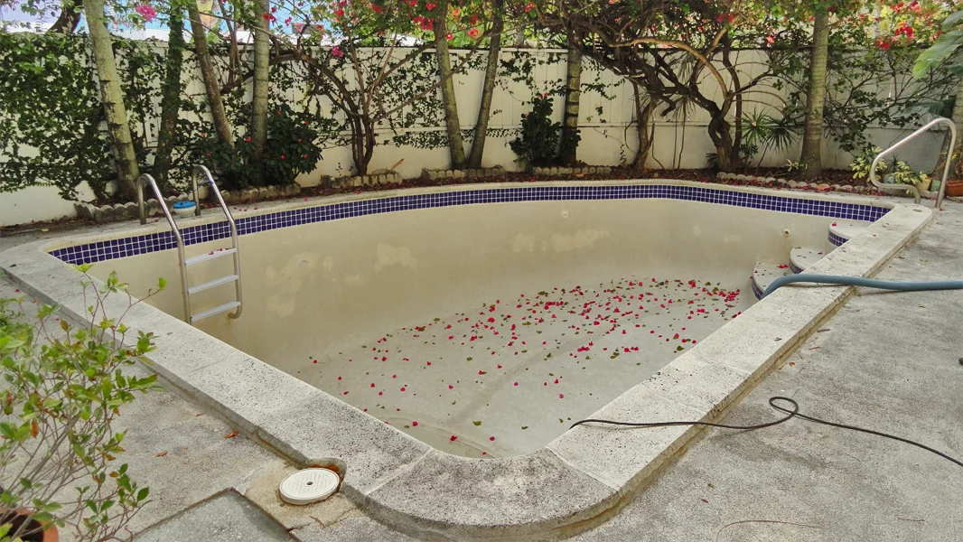 Old stained pool plaster before resurfacing in Miami FL