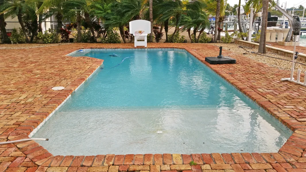 Old stained pool plaster before resurfacing in Miami FL