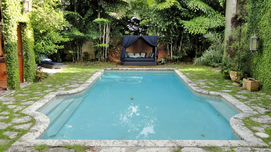 Old stained pool plaster before resurfacing in Miami FL